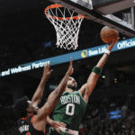 
              Boston Celtics forward Jayson Tatum (0) goes for the layup as Toronto Raptors forward Thaddeus Young (21) defends during the second half of an NBA basketball game in Toronto, Monday, Dec. 5, 2022. (Chris Young/The Canadian Press via AP)
            