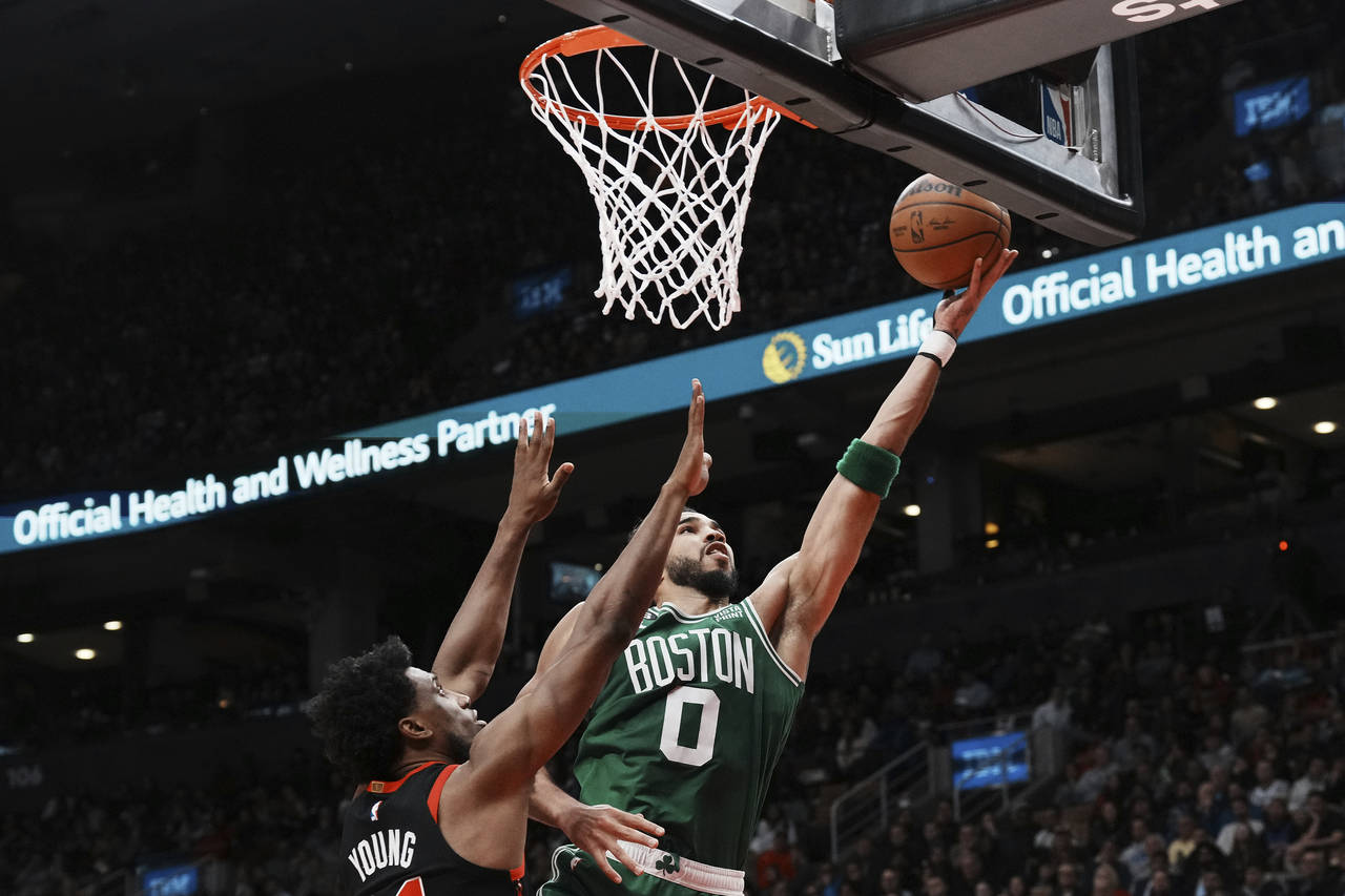 Boston Celtics forward Jayson Tatum (0) goes for the layup as Toronto Raptors forward Thaddeus Youn...