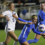 
              North Carolina's Maddie Dahlien (5) and UCLA's Quincy McMahon battle for the ball during the first half of the NCAA women's soccer tournament final in Cary, N.C., Monday, Dec. 5, 2022. (AP Photo/Ben McKeown) (AP Photo/Ben McKeown)
            