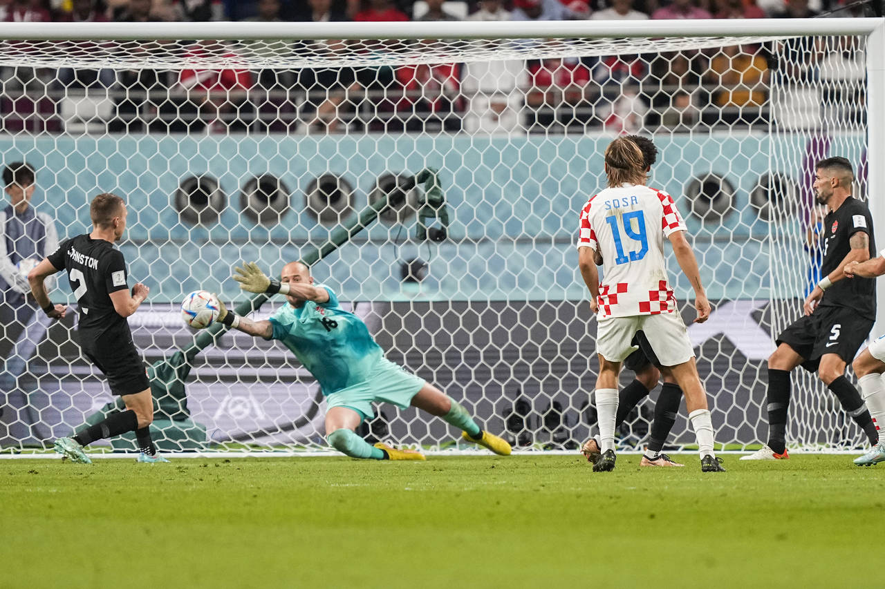 Canada's goalkeeper Milan Borjan, center, defends a shot during the World Cup group F soccer match ...