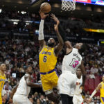 
              Los Angeles Lakers forward LeBron James (6) shoots as Miami Heat center Bam Adebayo (13) defends during the second half of an NBA basketball game, Wednesday, Dec. 28, 2022, in Miami. The Heat won 112-98. (AP Photo/Lynne Sladky)
            