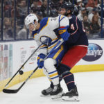
              Buffalo Sabres' Dylan Cozens, left, and Columbus Blue Jackets' Vladislav Gavrikov vie for the puck during the first period of an NHL hockey game Wednesday, Dec. 7, 2022, in Columbus, Ohio. (AP Photo/Jay LaPrete)
            