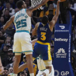 
              Charlotte Hornets forward P.J. Washington, left, blocks a shot by Golden State Warriors guard Jordan Poole during the first half of an NBA basketball game in San Francisco, Tuesday, Dec. 27, 2022. (AP Photo/Godofredo A. Vásquez)
            