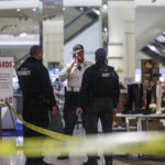 
              Security officers speak inside a store at the Mall of America in Bloomington, Minn., after reports of shots fired on Friday, Dec. 23, 2022. (Kerem Yücel/Minnesota Public Radio via AP)
            