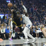 
              Golden State Warriors forward Draymond Green passes the ball while defended by Memphis Grizzlies forward Jaren Jackson Jr. during the first half of an NBA basketball game in San Francisco, Sunday, Dec. 25, 2022. (AP Photo/Godofredo A. Vásquez)
            