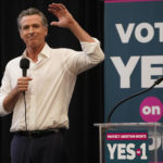 
              FILE - California Governor Gavin Newsom urges voters to turn out and vote YES on Proposition 1 at a rally at Long Beach City College in Long Beach, Calif., Sunday, Nov. 6, 2022.  A variety of new laws take effect Sunday, Jan. 1, 2023 that could have an impact on people's finances and, in some cases, their personal liberties. (AP Photo/Damian Dovarganes, File)
            