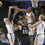 
              Phoenix Suns center Bismack Biyombo defends against Memphis Grizzlies forward Jaren Jackson Jr. in the first half of an NBA basketball game, Tuesday, Dec. 27, 2022, in Memphis, Tenn. (AP Photo/Brandon Dill)
            