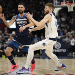 
              Minnesota Timberwolves guard Austin Rivers (25) passes while defended by Dallas Mavericks forward Davis Bertans (44) during the first half of an NBA basketball game, Wednesday, Dec. 21, 2022, in Minneapolis. (AP Photo/Abbie Parr)
            