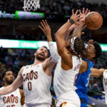 
              From left, Cleveland Cavaliers forward Kevin Love (0), forward Lamar Stevens (8), Dallas Mavericks forward Christian Wood (35), and Cleveland Cavaliers center Jarrett Allen (31) battle for a rebound in the first half of an NBA basketball game in Dallas, Wednesday, Dec. 14, 2022. (AP Photo/Emil Lippe)
            