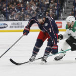 
              Columbus Blue Jackets' Sean Kuraly, left, moves the puck across the blue line past Dallas Stars' Jani Hakanpaa during the second period of an NHL hockey game on Monday, Dec. 19, 2022, in Columbus, Ohio. (AP Photo/Jay LaPrete)
            