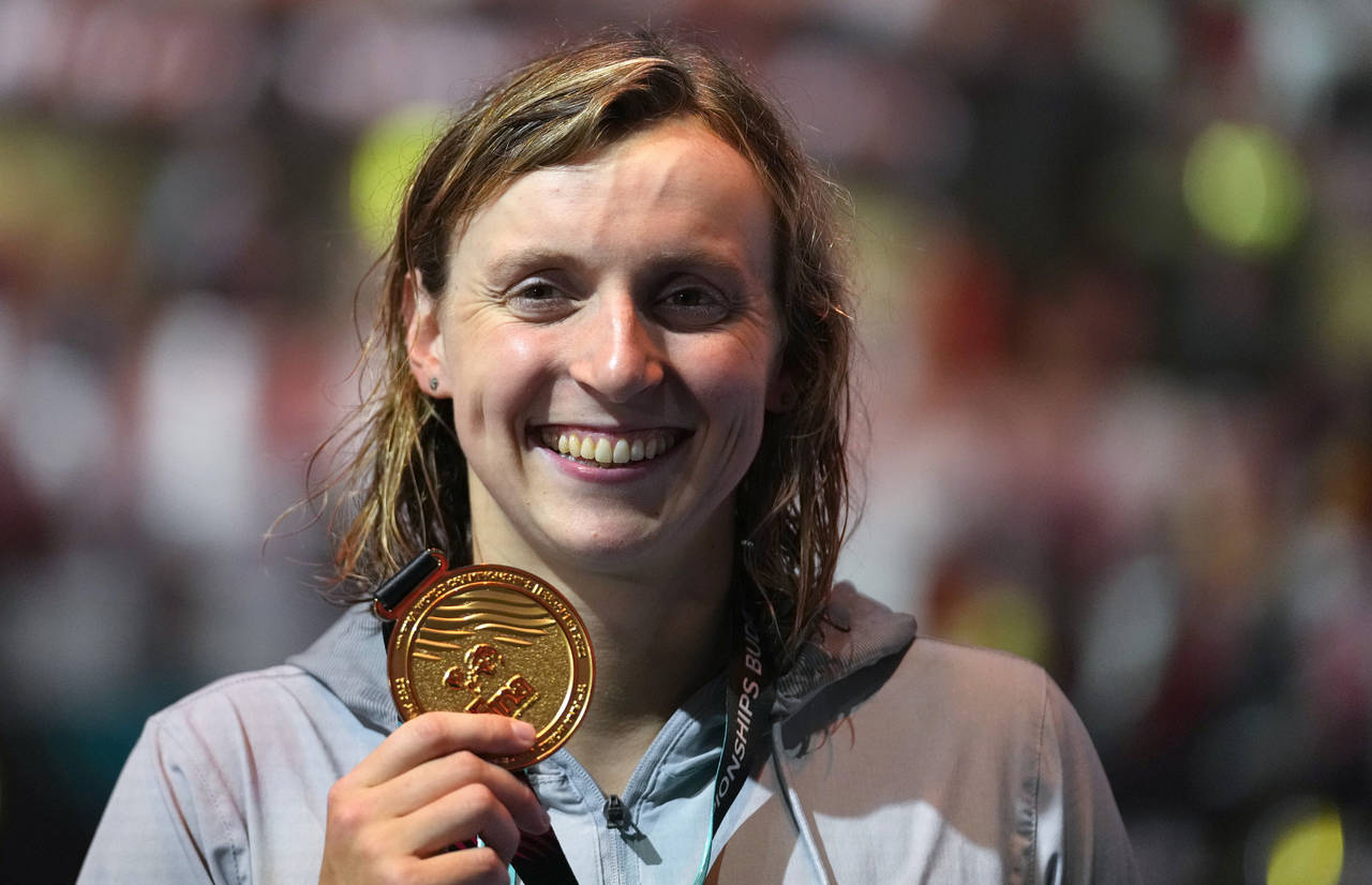 FILE - Gold medalist Katie Ledecky of the United States poses with her medal after the Women 800m F...