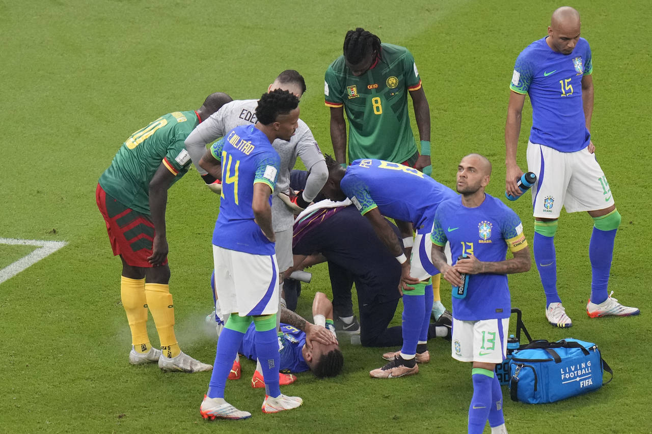 Brazil's Alex Telles is injured during the World Cup group G soccer match between Cameroon and Braz...