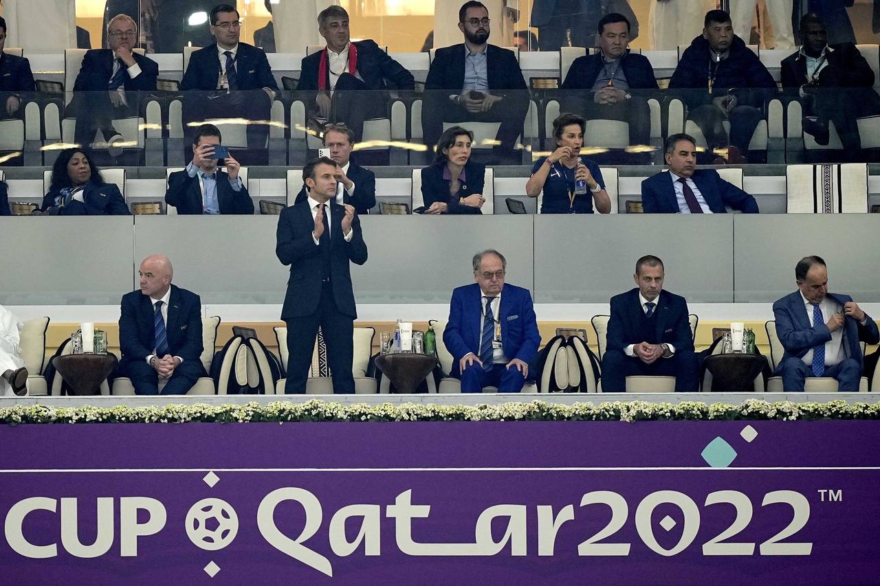 French President Emmanuel Macron applauds after the World Cup semifinal soccer match between France...