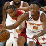 
              New York Knicks guard Immanual Quickley (5) grabs the ball in front of Cleveland Cavaliers guard Isaac Okoro during the second half of an NBA basketball game, Sunday, Dec. 4, 2022, in New York. The Knicks won 92-81. (AP Photo/John Munson)
            