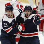 
              Washington Capitals center Nic Dowd (26) celebrates after his goal with right wing Garnet Hathaway (21) during the second period of an NHL hockey game against the Detroit Red Wings, Monday, Dec. 19, 2022, in Washington. (AP Photo/Nick Wass)
            