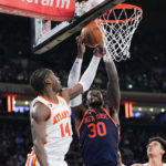 
              New York Knicks forward Julius Randle (30) and Atlanta Hawks forward AJ Griffin (14) vie for a rebound during the first half of an NBA basketball game Wednesday, Dec. 7, 2022, at Madison Square Garden in New York. (AP Photo/Mary Altaffer)
            