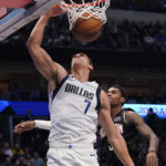 
              Dallas Mavericks center Dwight Powell (7) scores a basket against Houston Rockets guard Kevin Porter Jr. (3) during the first half of an NBA basketball game in Dallas, Thursday, Dec. 29, 2022. (AP Photo/LM Otero)
            