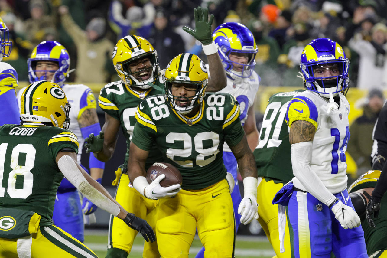 Green Bay Packers running back AJ Dillon (28) celebrates a touchdown against the Los angles Rams in...