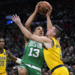 
              Boston Celtics guard Malcolm Brogdon (13) drives to the basket against Indiana Pacers guard T.J. McConnell, right, during the first half of an NBA basketball game Wednesday, Dec. 21, 2022, in Boston. (AP Photo/Charles Krupa)
            