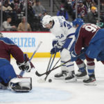 
              Toronto Maple Leafs center Auston Matthews, center, tries to redirect the puck at Colorado Avalanche goaltender Alexandar Georgiev, left, as Avalanche right wing Mikko Rantanen, right, defends in the second period of an NHL hockey game Saturday, Dec. 31, 2022, in Denver. (AP Photo/David Zalubowski)
            