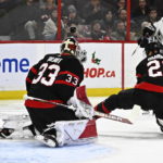 
              Los Angeles Kings defenseman Mikey Anderson scores on Ottawa Senators goaltender Cam Talbot (33) as defenseman Travis Hamonic (23) attempts to block a shot, during the first period of an NHL hockey game, Tuesday, Dec. 6, 2022, in Ottawa, Ontario. (Justin Tang/The Canadian Press via AP)
            