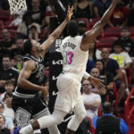 
              Miami Heat center Bam Adebayo (13) is fouled by San Antonio Spurs center Charles Basseyn (28) during the first half of an NBA basketball game, Saturday, Dec. 10, 2022, in Miami. (AP Photo/Lynne Sladky)
            
