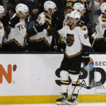 
              Boston Bruins' David Pastrnak is congratulated at the bench after scoring against the Colorado Avalanche during the first period of an NHL hockey game Saturday, Dec. 3, 2022, in Boston. (AP Photo/Winslow Townson)
            