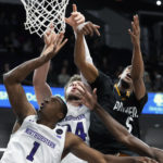 
              Prairie View A&M guard Kortrijk Miles, right, battles for a rebound against Northwestern guard Chase Audige (1) and center Matthew Nicholson during the second half of an NCAA college basketball game in Evanston, Ill., Sunday, Dec. 11, 2022. Northwestern won 61-51. (AP Photo/Nam Y. Huh)
            