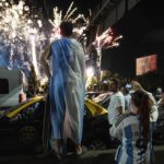 
              Soccer fans watch fireworks welcoming home the players from the Argentine soccer team that won the World Cup after they landed at Ezeiza airport on the outskirts of Buenos Aires, Argentina, Tuesday, Dec. 20, 2022. (AP Photo/Rodrigo Abd)
            
