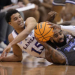 
              Seton Hall guard Jamir Harris, right, looks to pass under pressure from Kansas guard Kevin McCullar Jr., left, during the first half of an NCAA college basketball game Thursday, Dec. 1, 2022, in Lawrence, Kan. (AP Photo/Charlie Riedel)
            