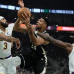 
              during Milwaukee Bucks' Giannis Antetokounmpo is fouled driving between Los Angeles Lakers' Anthony Davis and Lonnie Walker IV the first half of an NBA basketball game Friday, Dec. 2, 2022, in Milwaukee. (AP Photo/Morry Gash)
            