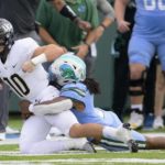 
              Tulane linebacker Dorian Williams (2) sacks Central Florida quarterback John Rhys Plumlee (10) during the first half of the American Athletic Conference championship NCAA college football game in New Orleans, Saturday, Dec. 3, 2022. (AP Photo/Matthew Hinton)
            