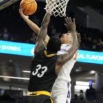 
              Northwestern guard Ty Berry, right, drives to the basket against Prairie View A&M forward Mckinley Harris during the second half of an NCAA college basketball game in Evanston, Ill., Sunday, Dec. 11, 2022. Northwestern won 61-51. (AP Photo/Nam Y. Huh)
            