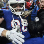 
              Buffalo Bills tight end Dawson Knox celebrates with fans in the stands after scoring a touchdown during the first half of an NFL football game against the New York Jets, Sunday, Dec. 11, 2022, in Orchard Park, N.Y. (AP Photo/Adrian Kraus)
            