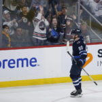 
              Winnipeg Jets' Pierre-Luc Dubois (80) and fans celebrate after he scored on a penalty shot against Vancouver Canucks goaltender Collin Delia during second-period NHL hockey game action in Winnipeg, Manitoba, Thursday, Dec. 29, 2022. (John Woods/The Canadian Press via AP)
            