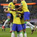 
              Brazil's Neymar, left and Brazil's Richarlison, right, celebrate with other team players after Vinicius Junior scored his side's opening goal during the World Cup round of 16 soccer match between Brazil and South Korea at the Stadium 974 in Doha, Qatar, Monday, Dec. 5, 2022. (AP Photo/Jin-Man Lee)
            