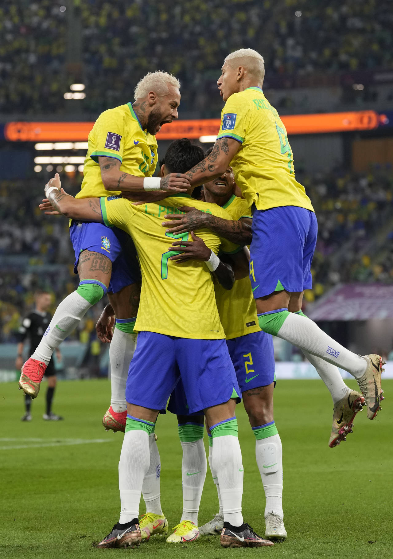 Brazil's Neymar, left and Brazil's Richarlison, right, celebrate with other team players after Vini...