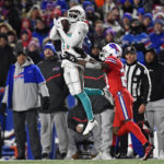 
              Miami Dolphins wide receiver Jaylen Waddle (17) makes a catch with Buffalo Bills cornerback Tre'Davious White (27) defending during the first half of an NFL football game in Orchard Park, N.Y., Saturday, Dec. 17, 2022. (AP Photo/Adrian Kraus)
            