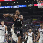 
              Los Angeles Clippers forward Kawhi Leonard (2) passesthe ball during the first half of an NBA basketball game against the Washington Wizards, Saturday, Dec. 17, 2022, in Los Angeles. (AP Photo/Marcio Jose Sanchez)
            