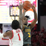 
              North Carolina A&T guard Kam Woods (3) takes a shot while defended by Houston guard Jamal Shead (1) during the first half of an NCAA college basketball game, Tuesday, Dec. 13, 2022, in Houston. (AP Photo/Kevin M. Cox)
            