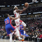 
              Chicago Bulls guard Ayo Dosunmu, right, drives to the basket past Detroit Pistons guard Jaden Ivey during the first half of an NBA basketball game in Chicago, Friday, Dec. 30, 2022. (AP Photo/Nam Y. Huh)
            