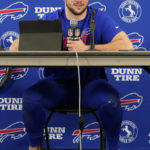
              Buffalo Bills quarterback Josh Allen attends a news conference barefoot after an NFL football game against the Chicago Bears Saturday, Dec. 24, 2022, in Chicago. The Bills won 35-13. (AP Photo/Charles Rex Arbogast)
            