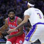 
              Philadelphia 76ers' Joel Embiid, left, tries to get past Los Angeles Lakers' Anthony Davis during the first half of an NBA basketball game, Friday, Dec. 9, 2022, in Philadelphia. (AP Photo/Matt Slocum)
            