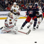 
              Chicago Blackhawks' Alex Stalock, left, makes a save against Columbus Blue Jackets' Kent Johnson during the second period of an NHL hockey game on Saturday, Dec. 31, 2022, in Columbus, Ohio. (AP Photo/Jay LaPrete)
            