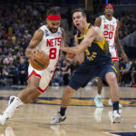 
              Brooklyn Nets guard Patty Mills (8) drives against Indiana Pacers guard T.J. McConnell (9) during the first half of an NBA basketball game in Indianapolis, Saturday, Dec. 10, 2022. (AP Photo/Doug McSchooler)
            