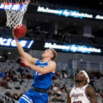 
              Boise State guard Jace Whiting (15) shoots a layup next to Texas A&M guard Tyrece Radford (23) during the first half of an NCAA college basketball game in Fort Worth, Texas, Saturday, Dec. 3, 2022. (AP Photo/Emil Lippe)
            