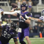 
              TCU quarterback Max Duggan (15) throws under pressure from Kansas State defensive end Felix Anudike-Uzomah (91) and linebacker Austin Moore (41) in the first half of the Big 12 Conference championship NCAA college football game, Saturday, Dec. 3, 2022, in Arlington, Texas. TCU running back Kendre Miller (33) is at bottom. (AP Photo/LM Otero)
            