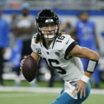 
              Jacksonville Jaguars quarterback Trevor Lawrence plays during the first half of an NFL football game against the Detroit Lions, Sunday, Dec. 4, 2022, in Detroit. (AP Photo/Duane Burleson)
            