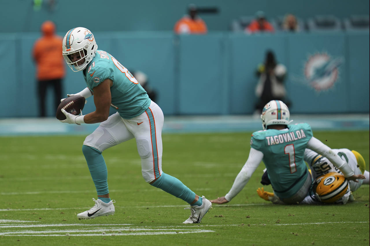 FILE - Miami Dolphins quarterback Tua Tagovailoa (1) gets tackled by Green Bay Packers linebacker K...