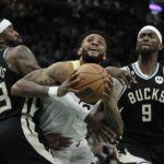 
              Utah Jazz's Nickeil Alexander-Walker drives between Milwaukee Bucks' Wesley Matthews and Bobby Portis during the second half of an NBA basketball game Saturday, Dec. 17, 2022, in Milwaukee. The Bucks won 123-97. (AP Photo/Morry Gash)
            